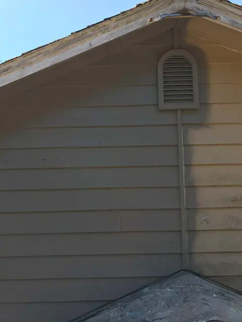 Weathered gable siding around a vent