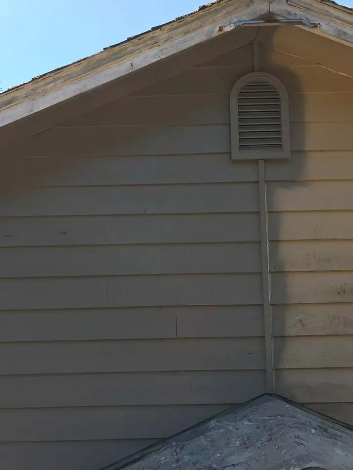Weathered gable siding around a vent