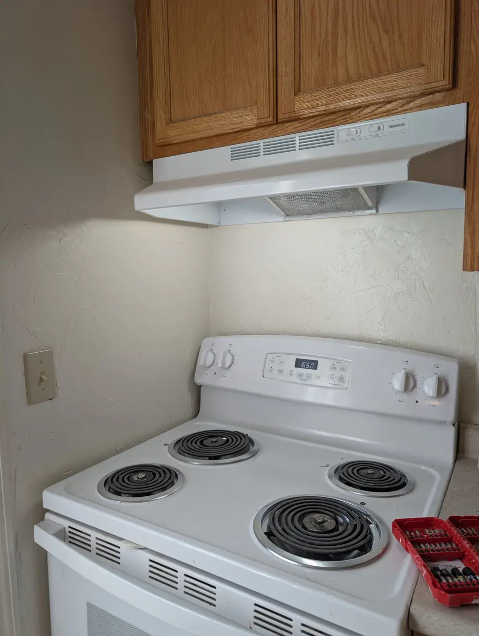 A kitchen corner painted, with the range in place under the hood
