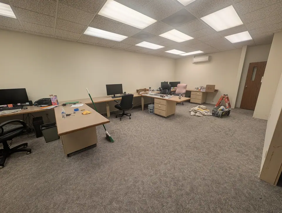 A business office after painting: cream walls, the desks back in place