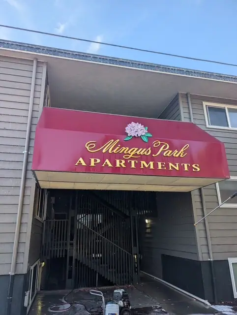 After: the same apartment entry awning washed, the red cover and gold letters clean